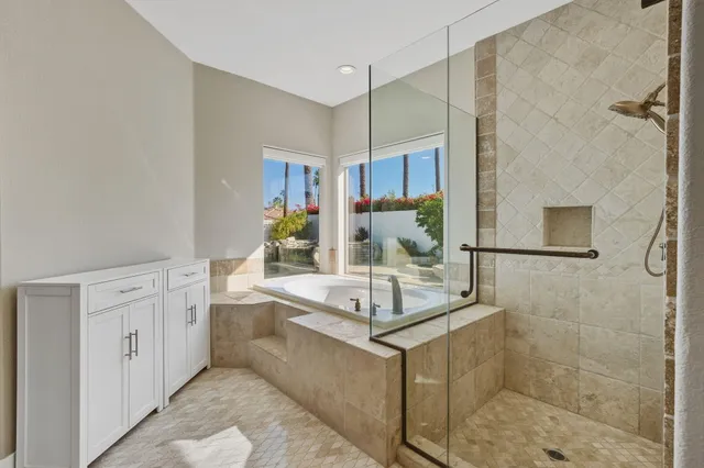 a bathroom with a tub sink and mirror