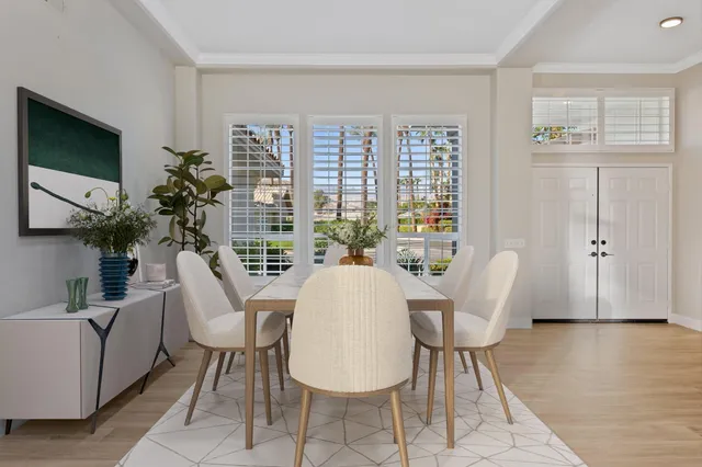 a living room with furniture a flat screen tv and a large window