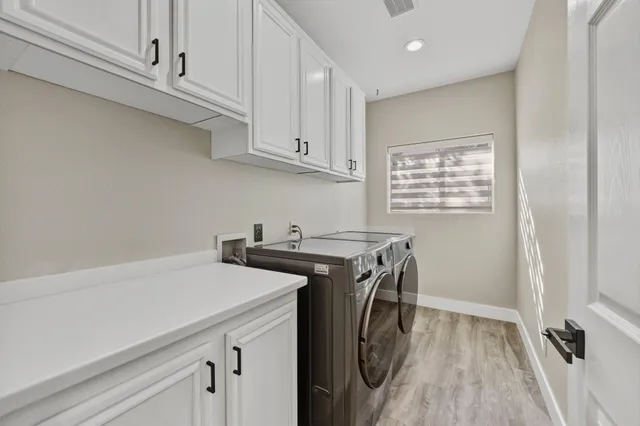 a view of a storage and utility room with wooden floor