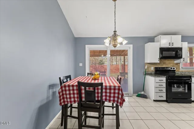 a view of a dining room with furniture wooden floor and chandelier