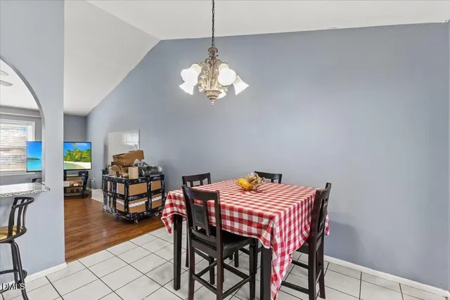 a view of a dining room with furniture and chandelier