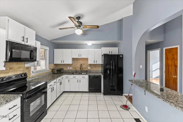 a kitchen with a sink stainless steel appliances and cabinets