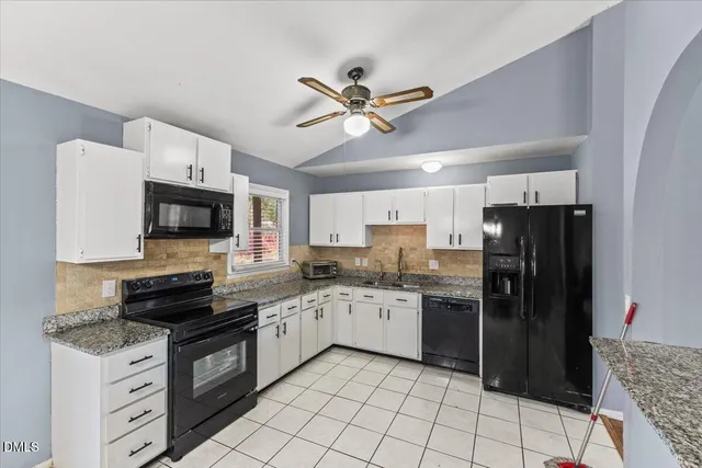 a kitchen with stainless steel appliances a stove refrigerator sink and microwave