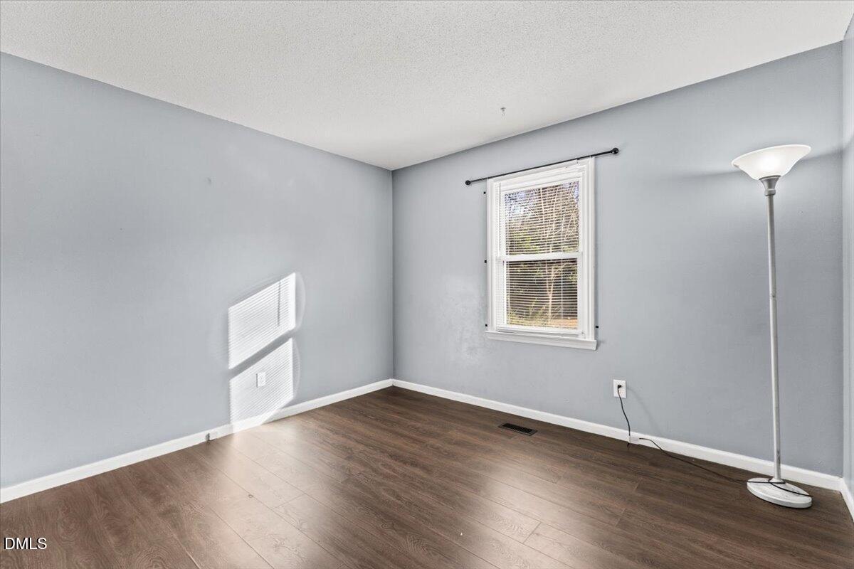 3612 Satellite Court Raleigh, NC 27604 - Photo 23 of 42 a view of an empty room with wooden floor and a window
