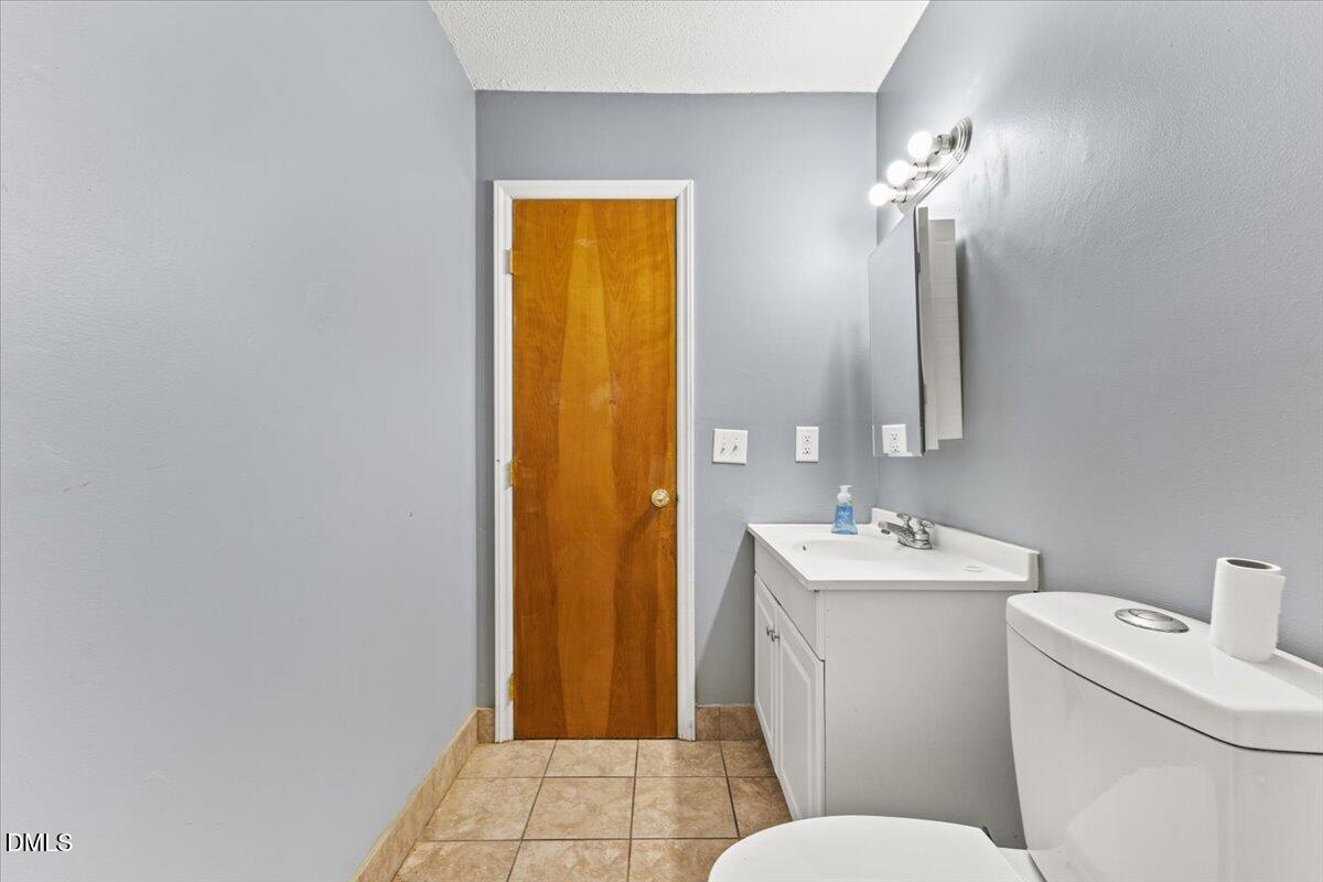3612 Satellite Court Raleigh, NC 27604 - Photo 29 of 42 a bathroom with a sink a toilet and shower