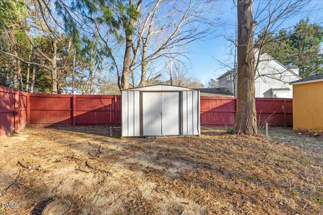 a view of a yard with large trees