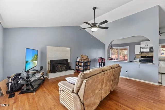 a living room with furniture a fireplace and a flat screen tv