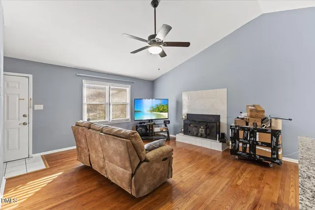 a living room with furniture a fireplace and a flat screen tv