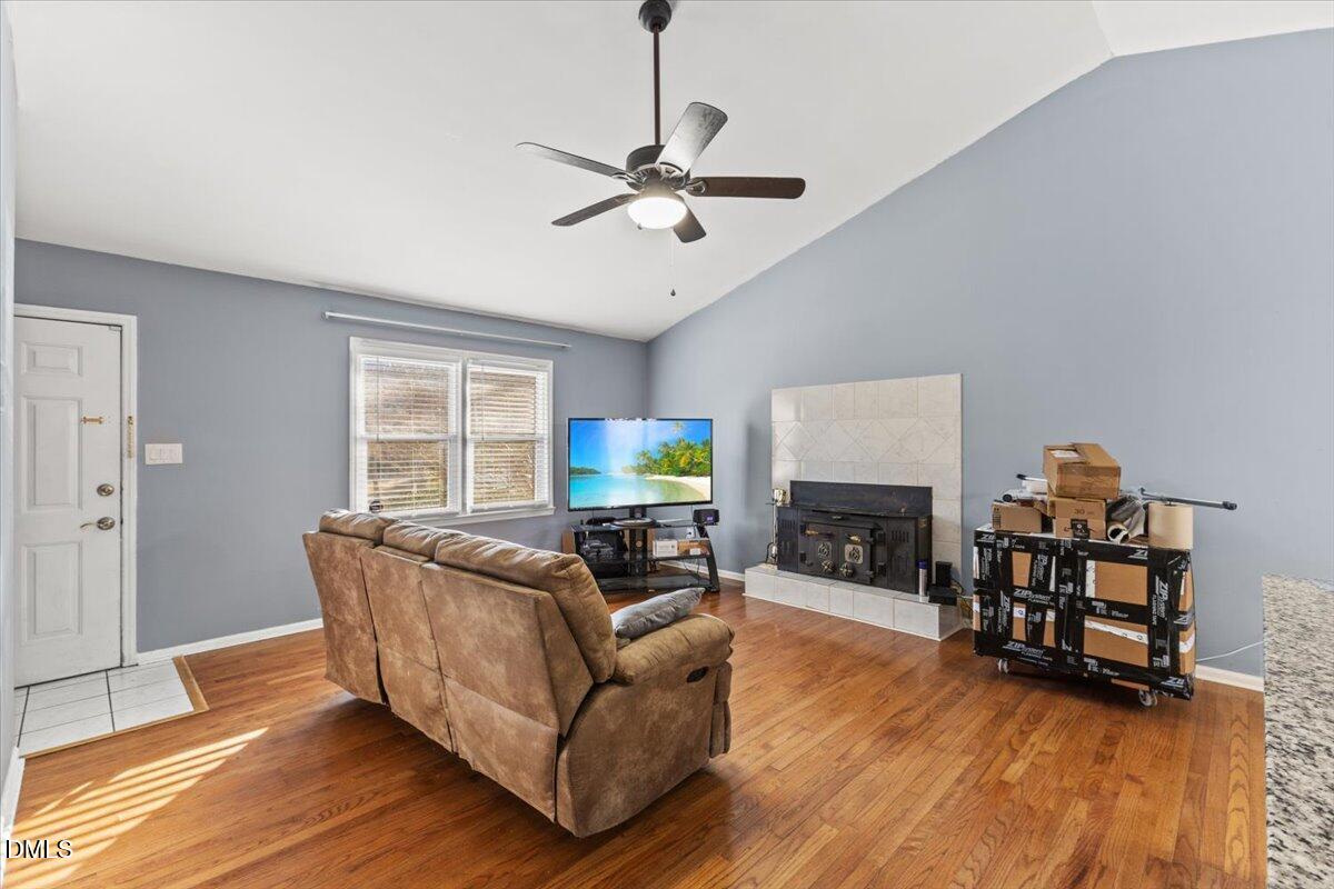 3612 Satellite Court Raleigh, NC 27604 - Photo 9 of 42 a living room with furniture a fireplace and a flat screen tv
