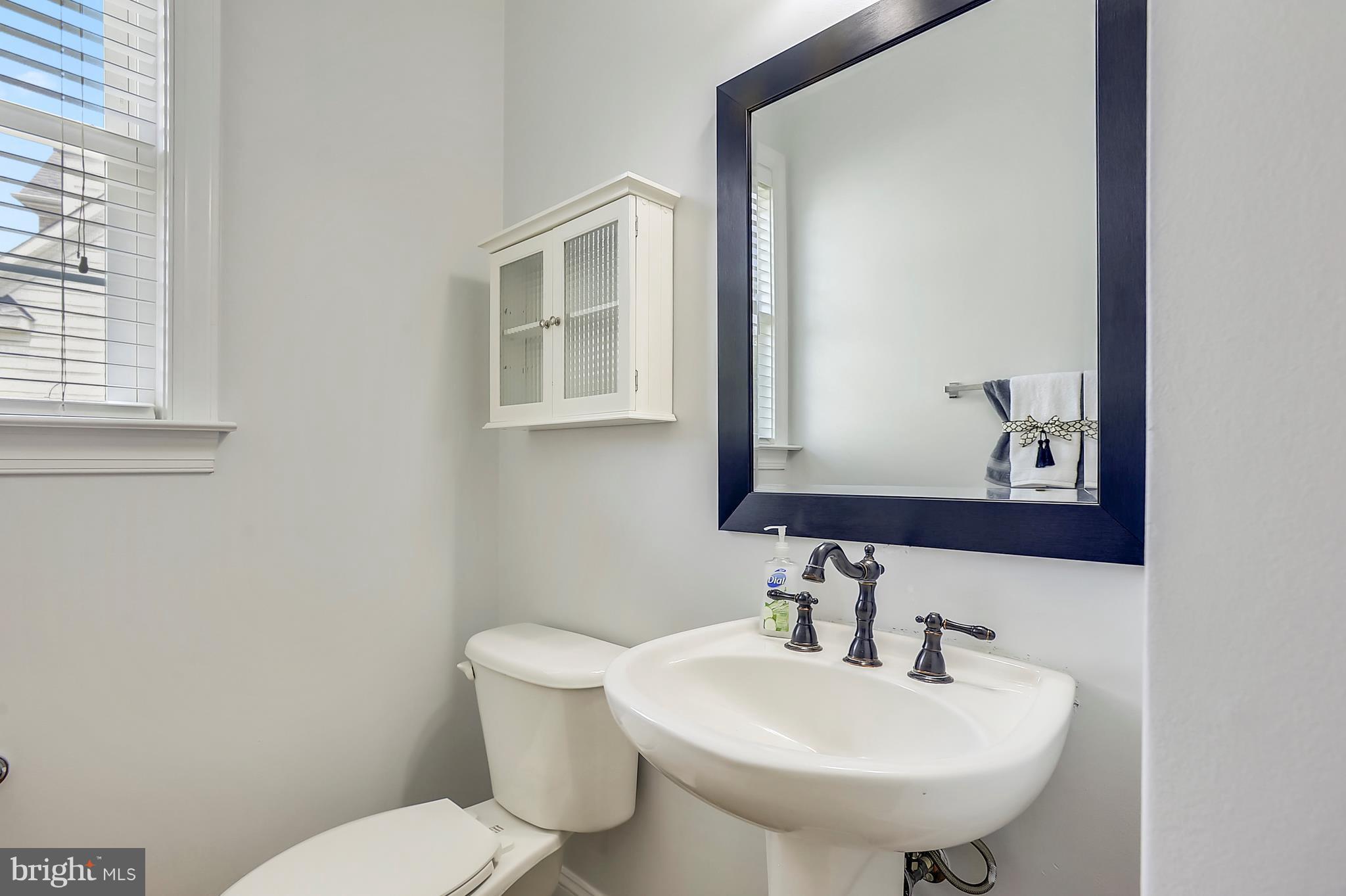 4855 Muddler Way Fairfax, VA 22030 - Photo 14 of 30 a bathroom with a toilet a sink and mirror