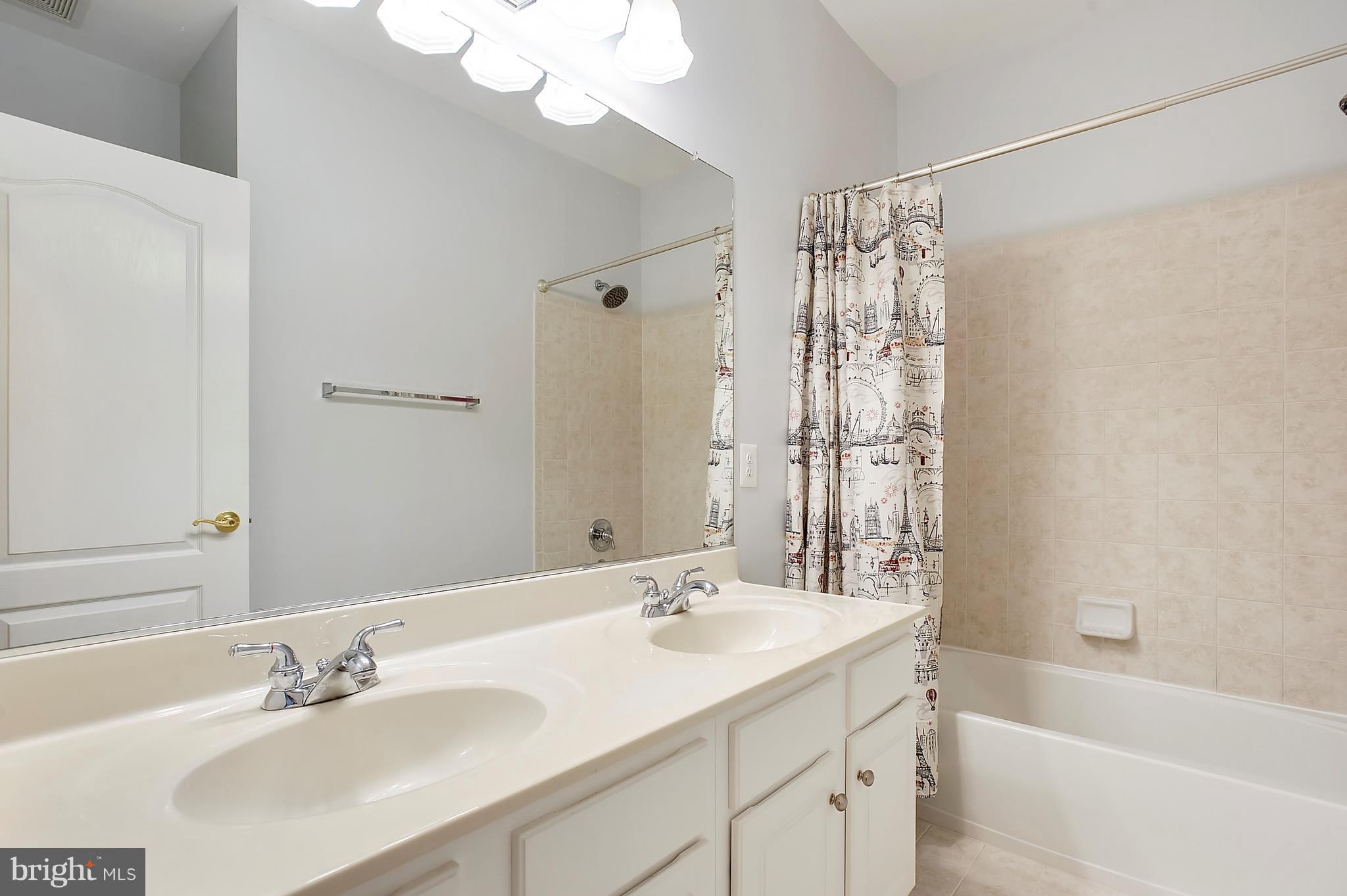 4855 Muddler Way Fairfax, VA 22030 - Photo 21 of 30 a bathroom with a double vanity sink and a mirror