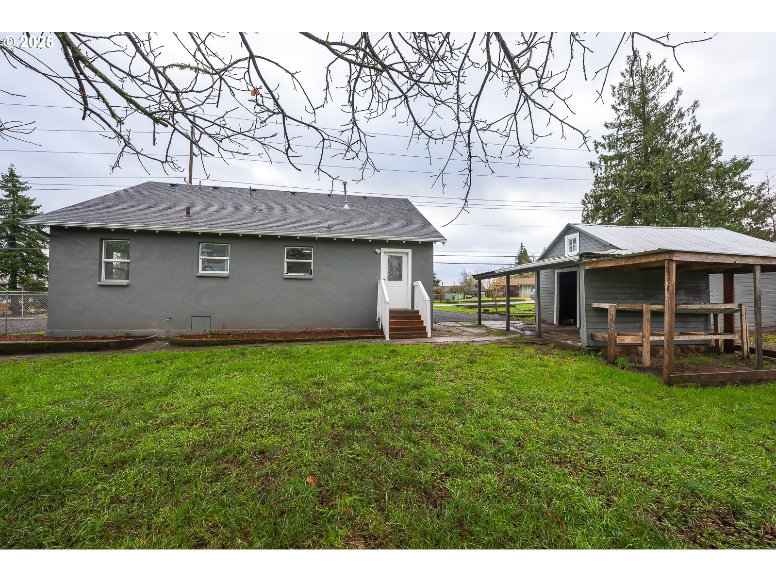 445 Southwest Mill Street Sheridan, OR 97378 - Photo 5 of 38 a backyard of a house with table and chairs