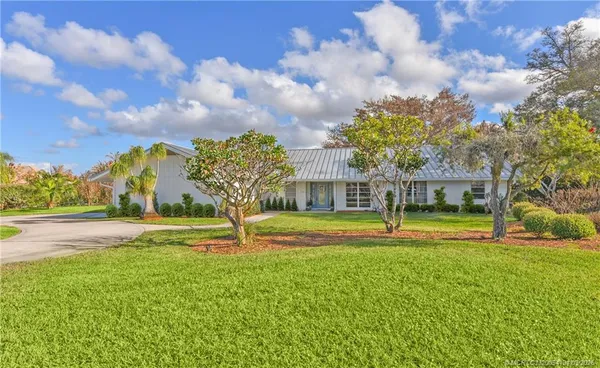 a view of a hallway with wooden floor and windows