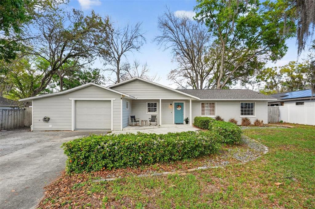 106 Portland Street Eustis, FL 32726 - Photo 18 of 71 a front view of a house with a yard and trees