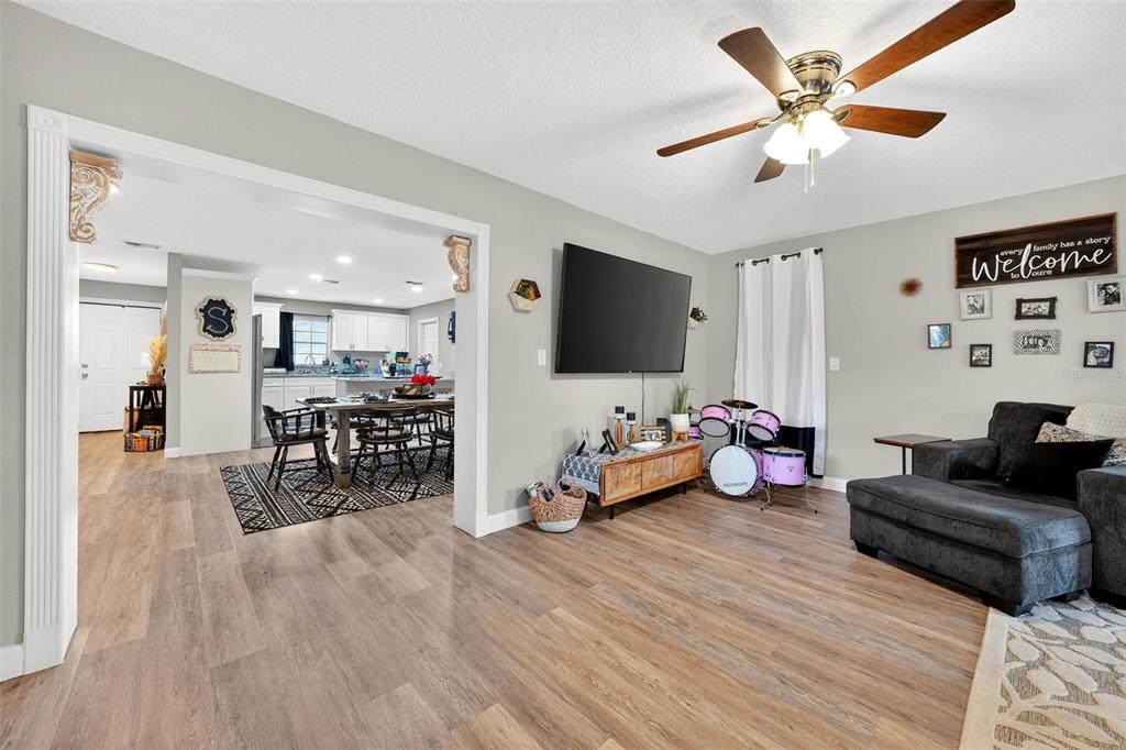 106 Portland Street Eustis, FL 32726 - Photo 35 of 71 a living room with furniture and a flat screen tv
