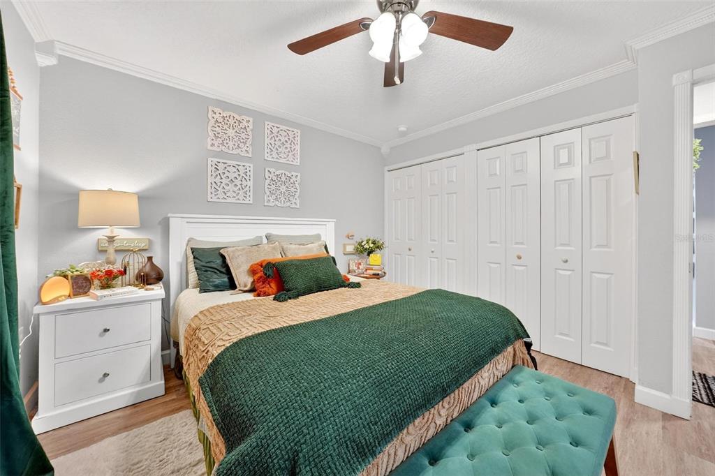 106 Portland Street Eustis, FL 32726 - Photo 49 of 71 a bedroom with a bed and a chandelier