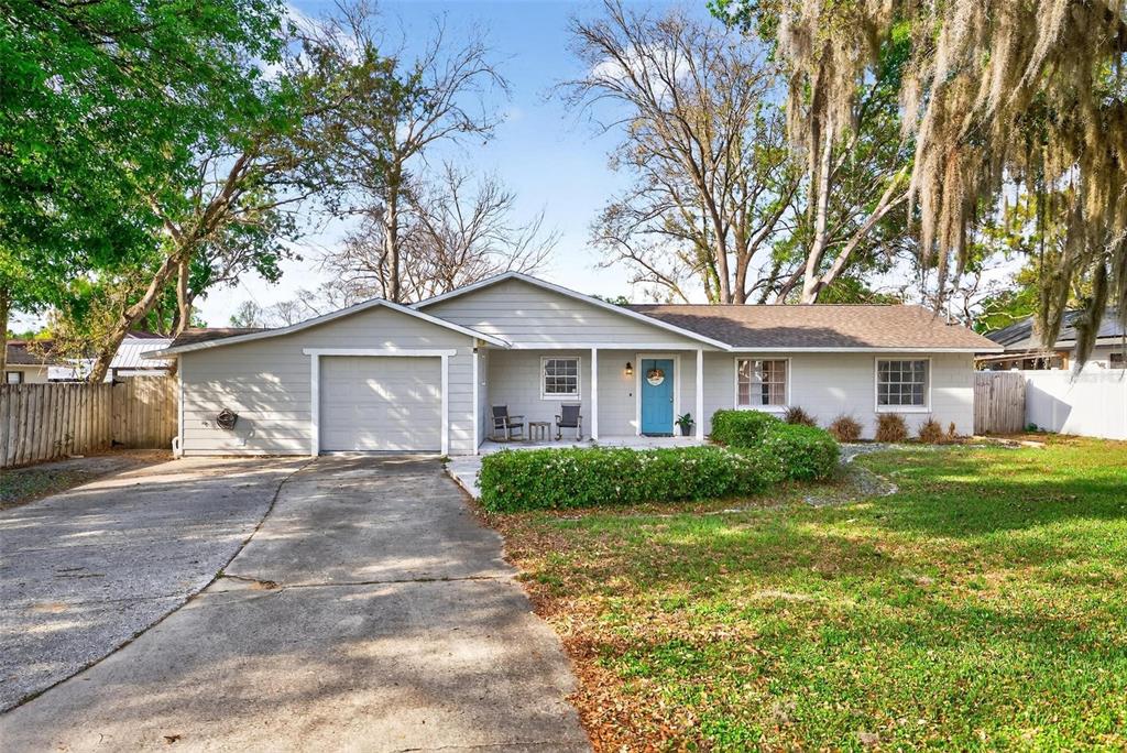 106 Portland Street Eustis, FL 32726 - Photo 62 of 71 a front view of a house with a yard and garage
