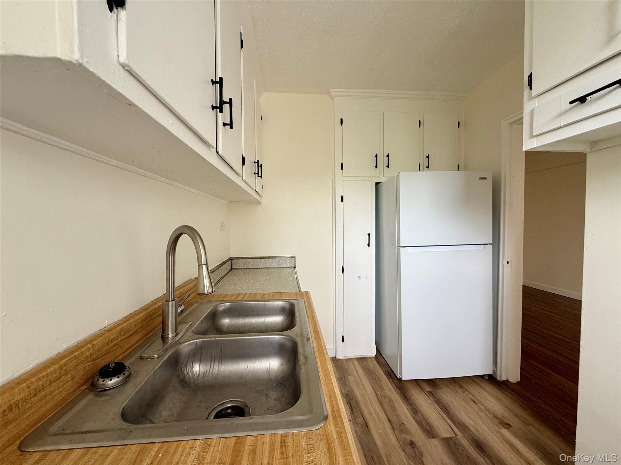 112-25 34th Avenue, Unit 6H Queens, NY 11368 - Photo 11 of 48 Kitchen with original wood cabinets, stainless steel sink, plenty of cabinets, large window for ventilation.