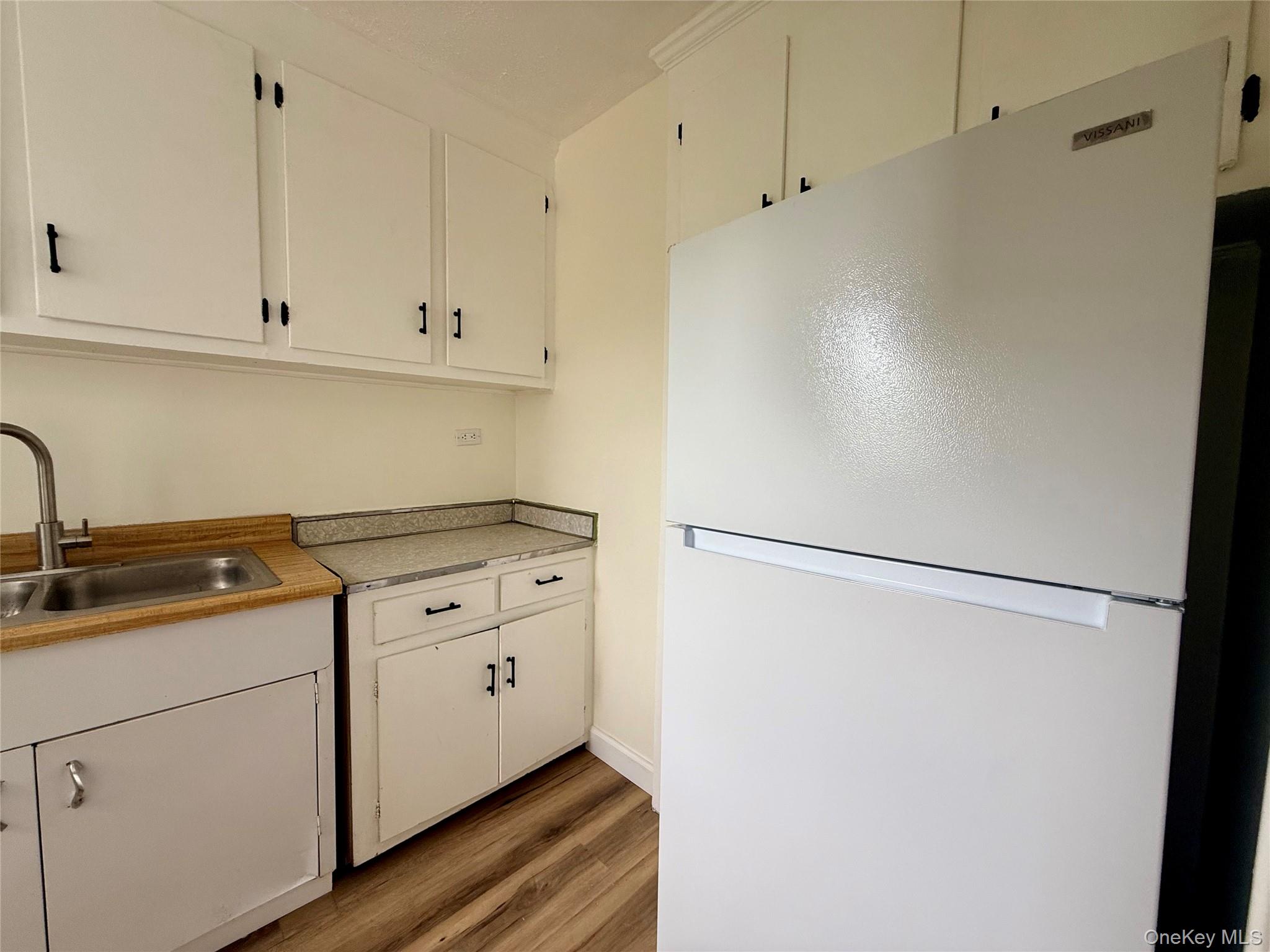 112-25 34th Avenue, Unit 6H Queens, NY 11368 - Photo 13 of 48 Kitchen with original wood cabinets, stainless steel sink, plenty of cabinets, large window for ventilation.