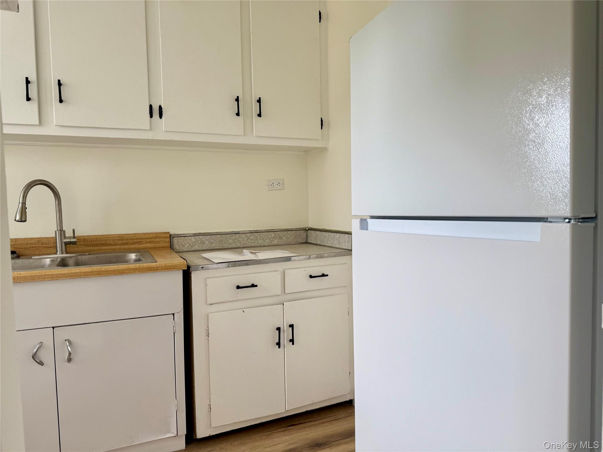 112-25 34th Avenue, Unit 6H Queens, NY 11368 - Photo 14 of 48 Kitchen with original wood cabinets, stainless steel sink, plenty of cabinets, large window for ventilation.