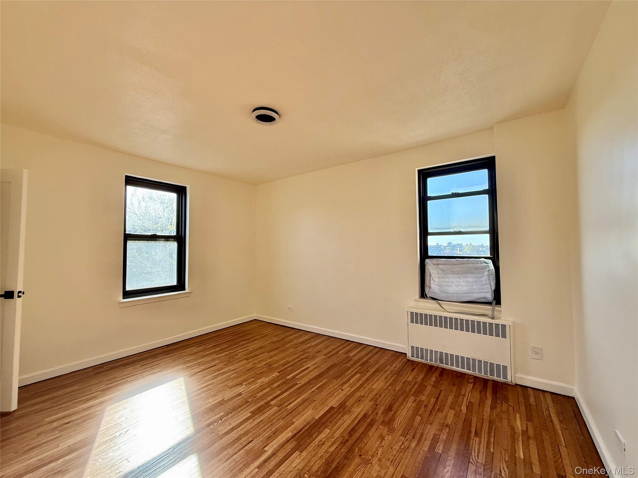 112-25 34th Avenue, Unit 6H Queens, NY 11368 - Photo 16 of 48 Corner bedroom with 2 opposite side windows, 2 closets. Ceiling light, hardwood floors. Great view of Cityfield