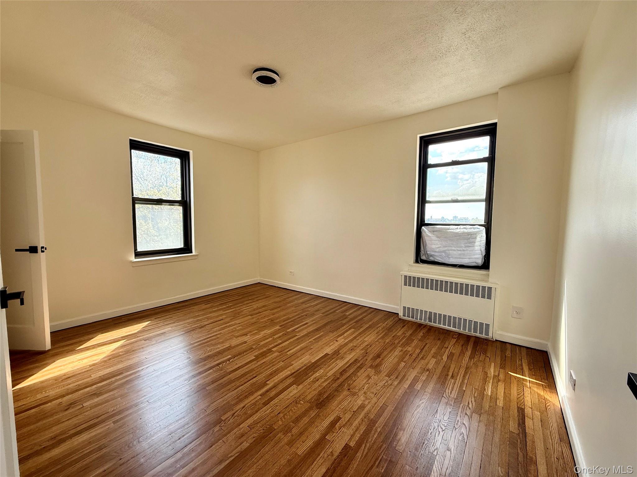 112-25 34th Avenue, Unit 6H Queens, NY 11368 - Photo 18 of 48 Corner bedroom with 2 opposite side windows, 2 closets. Ceiling light, hardwood floors. Great view of Cityfield