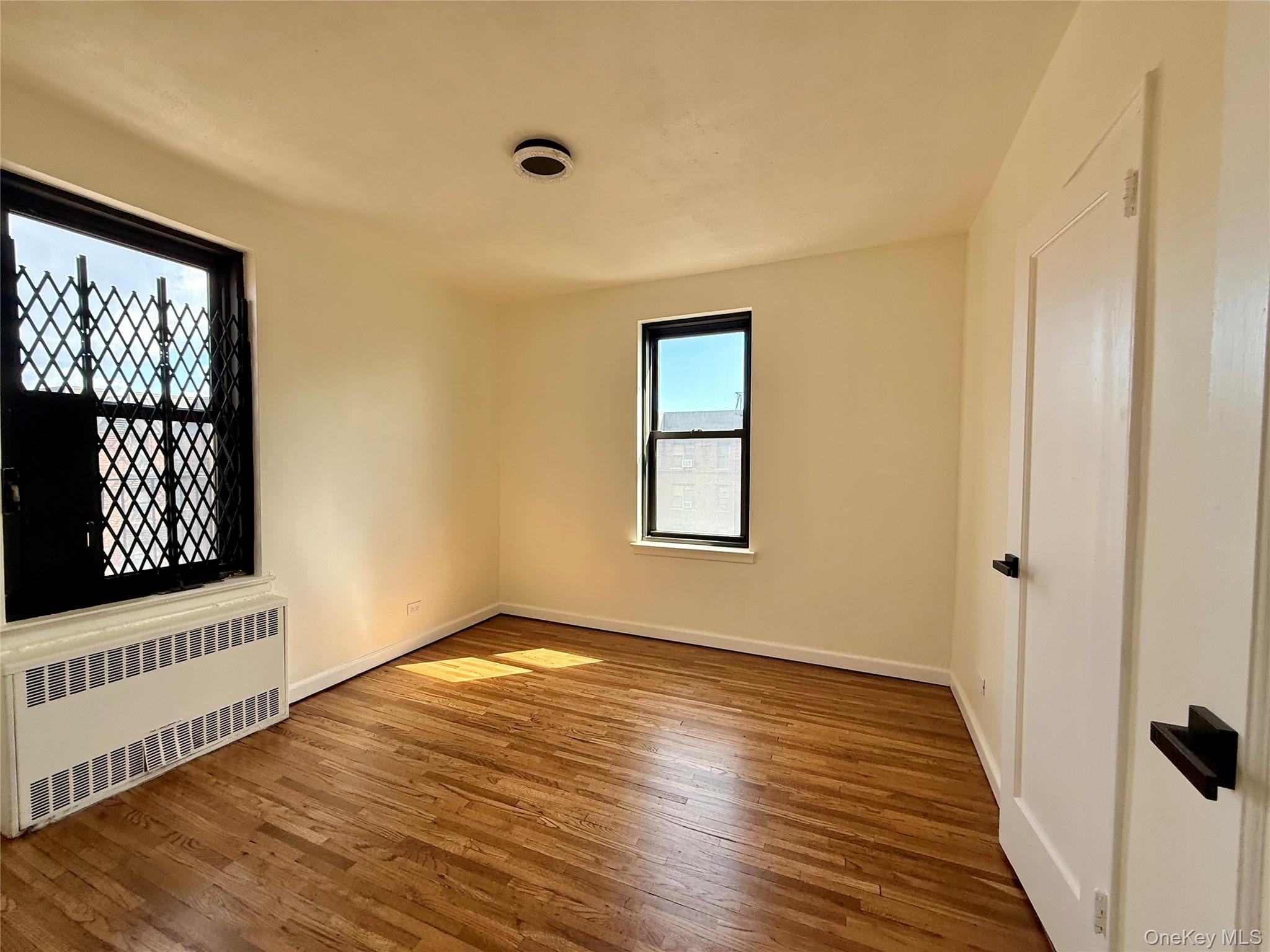 112-25 34th Avenue, Unit 6H Queens, NY 11368 - Photo 21 of 48 Second bedroom also a corner bedroom, 2 opposite side window, a large closet, ceiling lights and hardwood flooring.