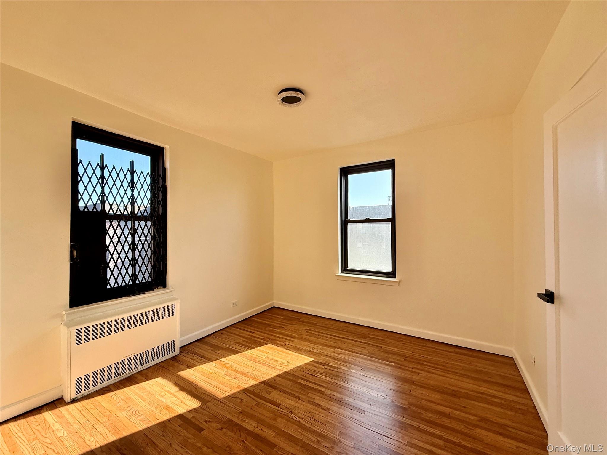 112-25 34th Avenue, Unit 6H Queens, NY 11368 - Photo 22 of 48 Second bedroom also a corner bedroom, 2 opposite side window, a large closet, ceiling lights and hardwood flooring.