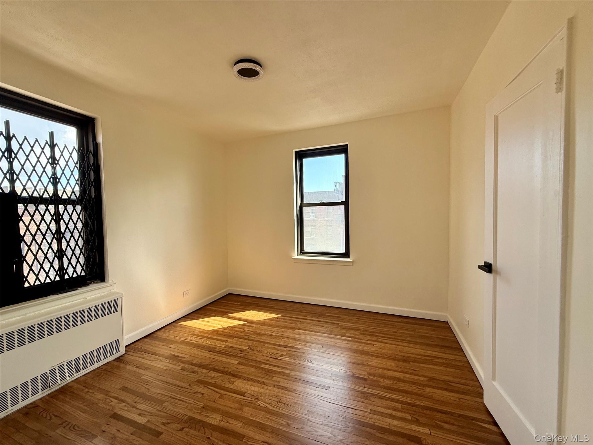 112-25 34th Avenue, Unit 6H Queens, NY 11368 - Photo 23 of 48 Second bedroom also a corner bedroom, 2 opposite side window, a large closet, ceiling lights and hardwood flooring.