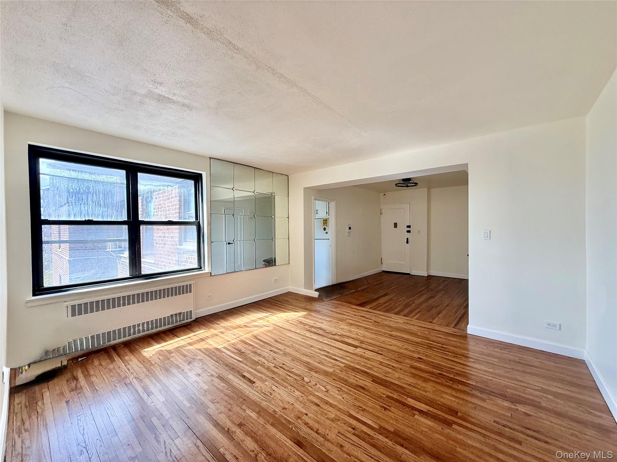 112-25 34th Avenue, Unit 6H Queens, NY 11368 - Photo 3 of 48 Large living room with double panel window, top floor provides excellent natural light, hardwood floors. Open to the dining area and kitchen.