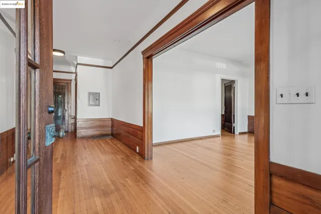 a view of a hallway with wooden floor