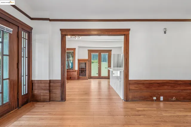 a view of a hallway with wooden floor and staircase
