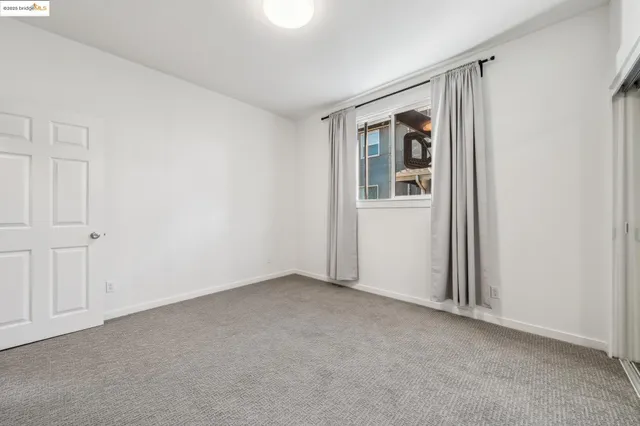 an empty room with closet and a bathroom