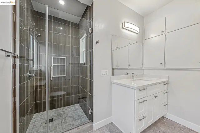 a bathroom with a shower sink and mirror