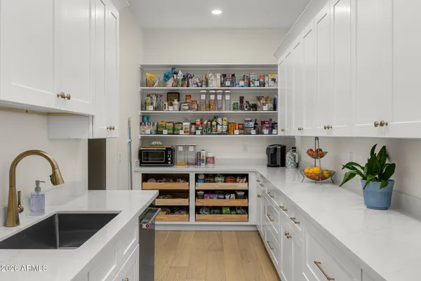 a kitchen with stainless steel appliances a sink a stove and cabinets