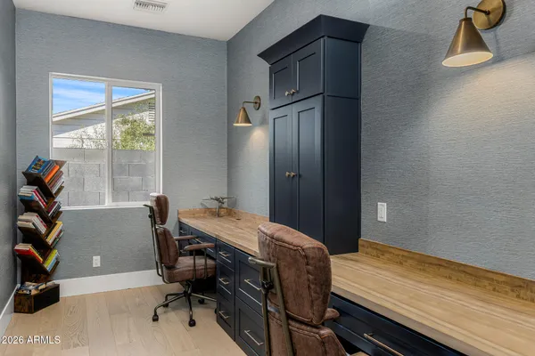 a view of a workspace with furniture and a window
