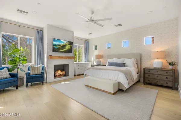 a spacious bedroom with a bed and a fireplace