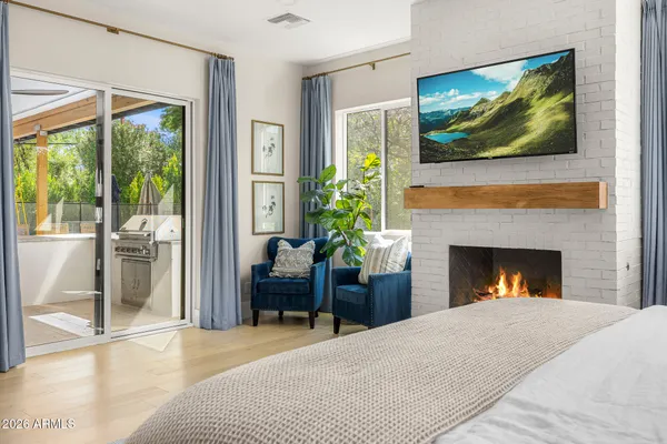 a bedroom with furniture and a fireplace