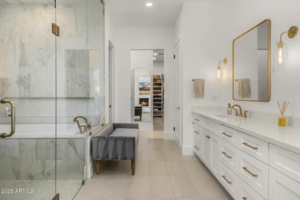a spacious bathroom with double vanity sinks a shower and a mirror