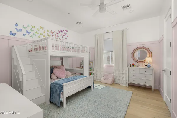 a bedroom with bed and cabinet