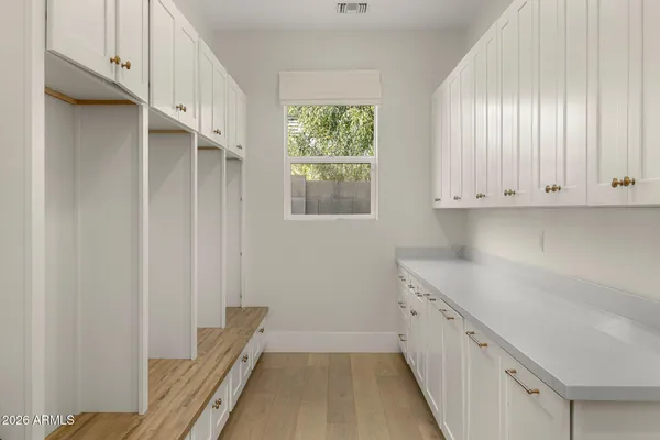 a kitchen with granite countertop white cabinets and window