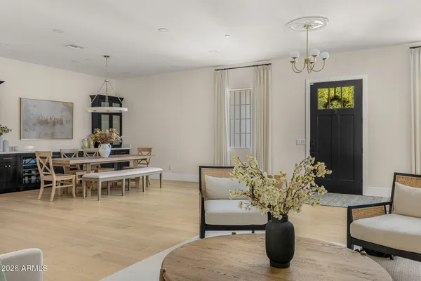 a dining room with furniture a chandelier and window