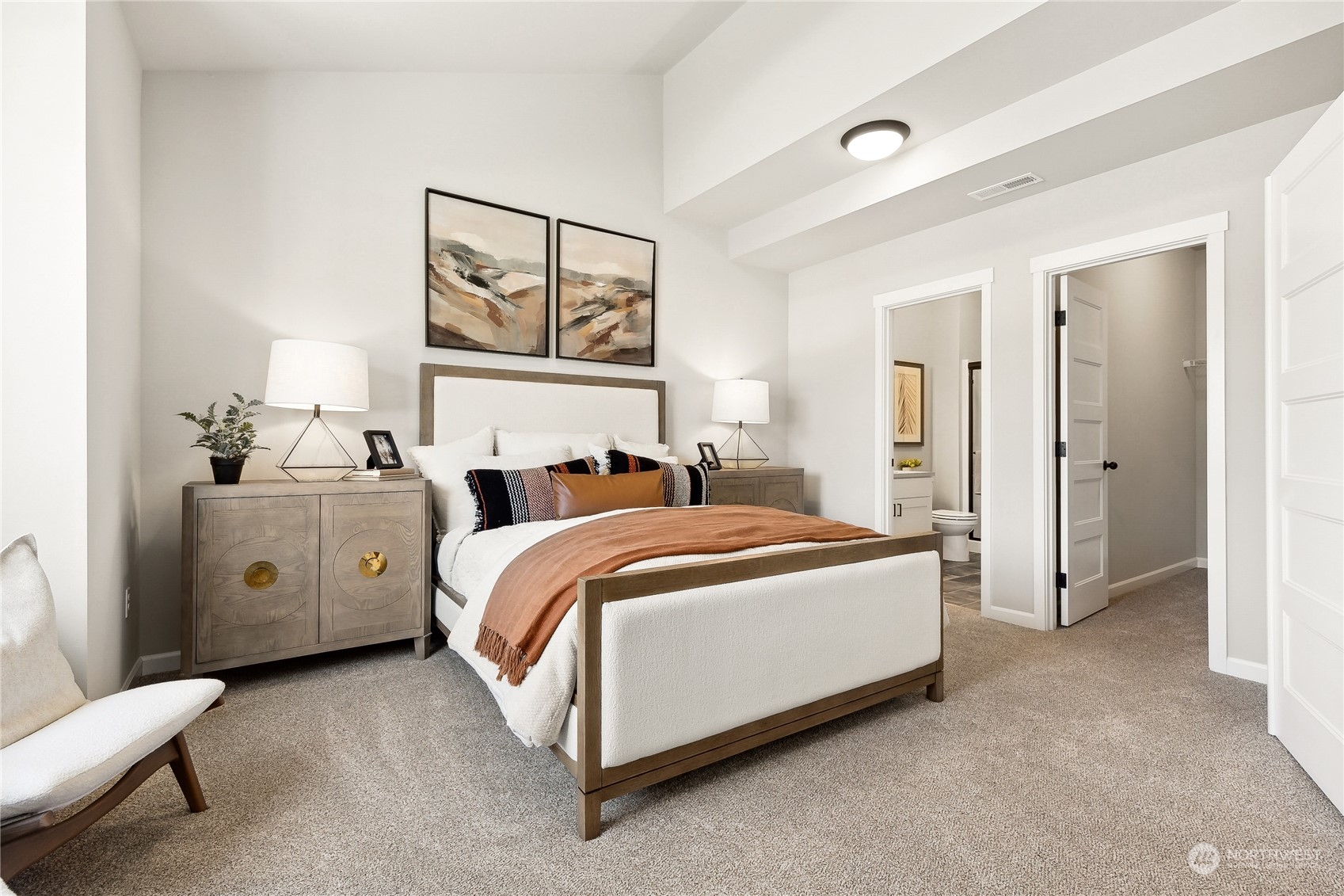 3016 Stephanie Loop Northeast Lacey, WA 98516 - Photo 6 of 19 a spacious bedroom with a bed and a painting on the wall