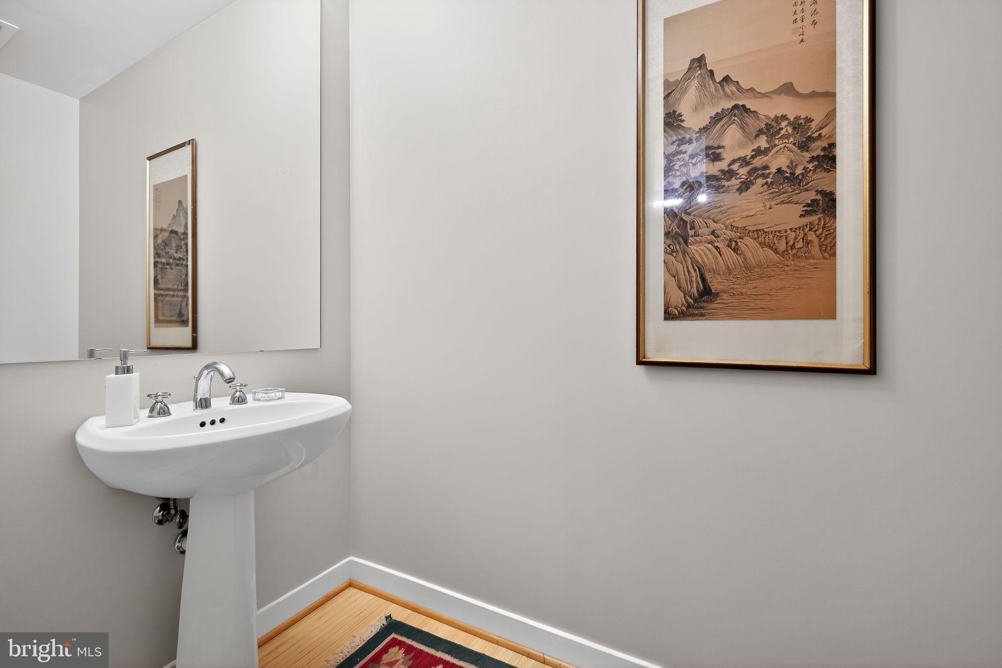 12025 New Dominion Parkway, Unit 311 Reston, VA 20190 - Photo 17 of 29 a bathroom with a sink and a mirror