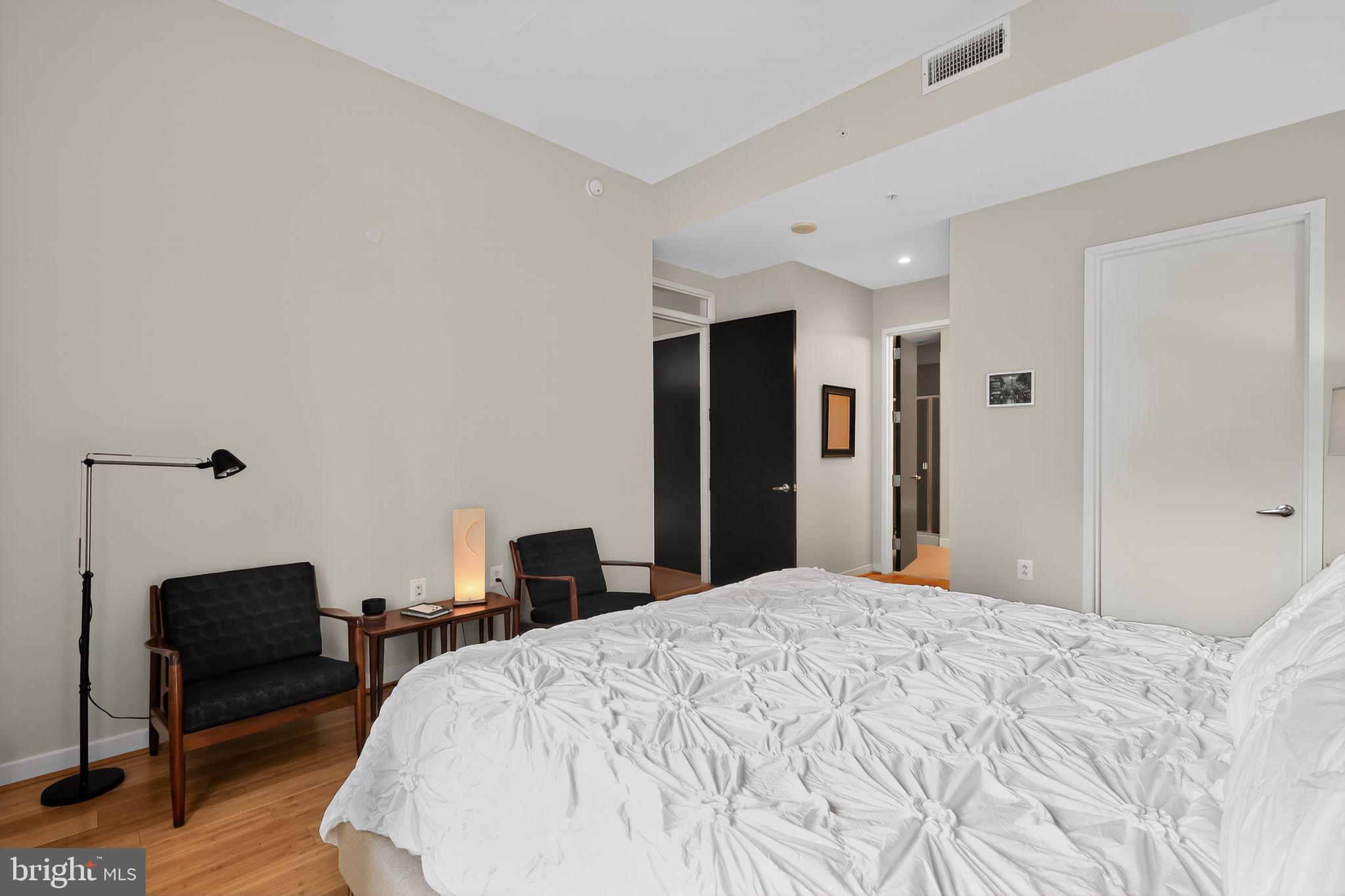 12025 New Dominion Parkway, Unit 311 Reston, VA 20190 - Photo 21 of 29 a bedroom with a bed and a chair