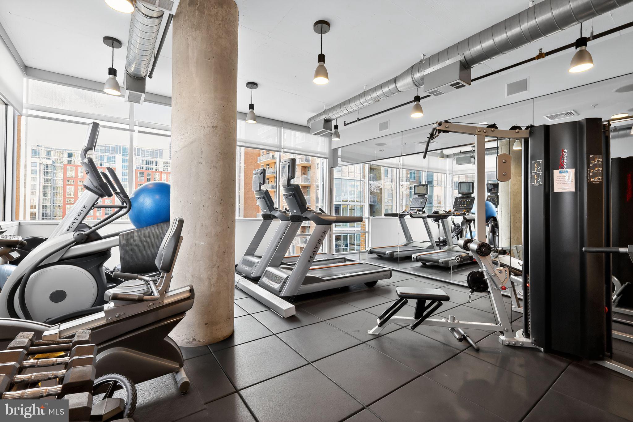 12025 New Dominion Parkway, Unit 311 Reston, VA 20190 - Photo 27 of 29 a room with gym equipment and glass windows