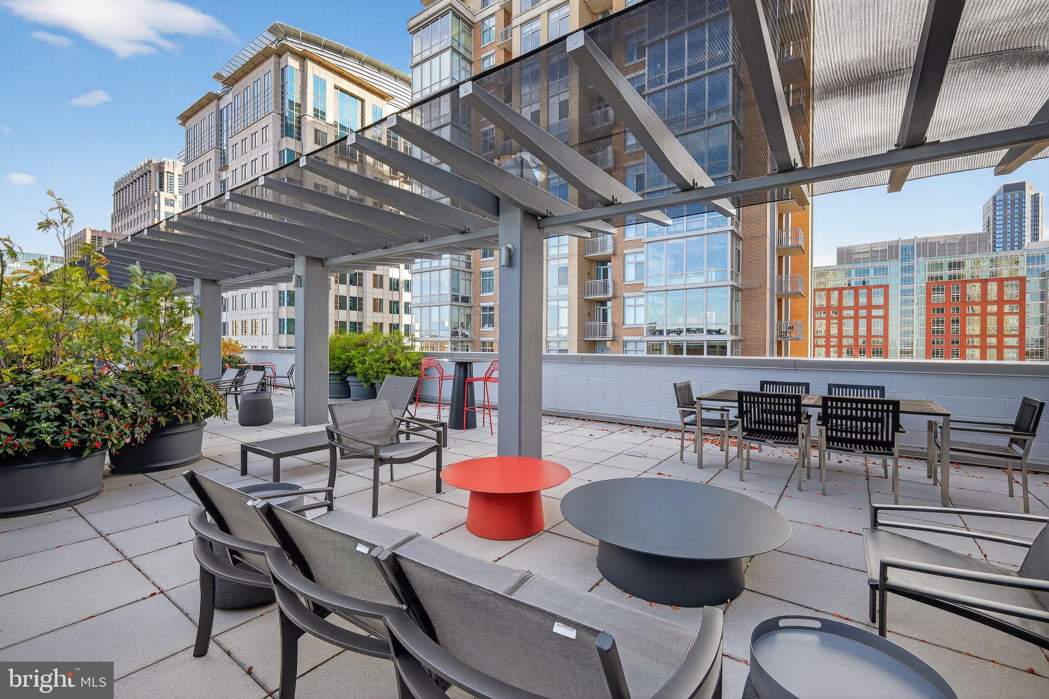 12025 New Dominion Parkway, Unit 311 Reston, VA 20190 - Photo 28 of 29 a dining room with furniture a chandelier and wooden floor