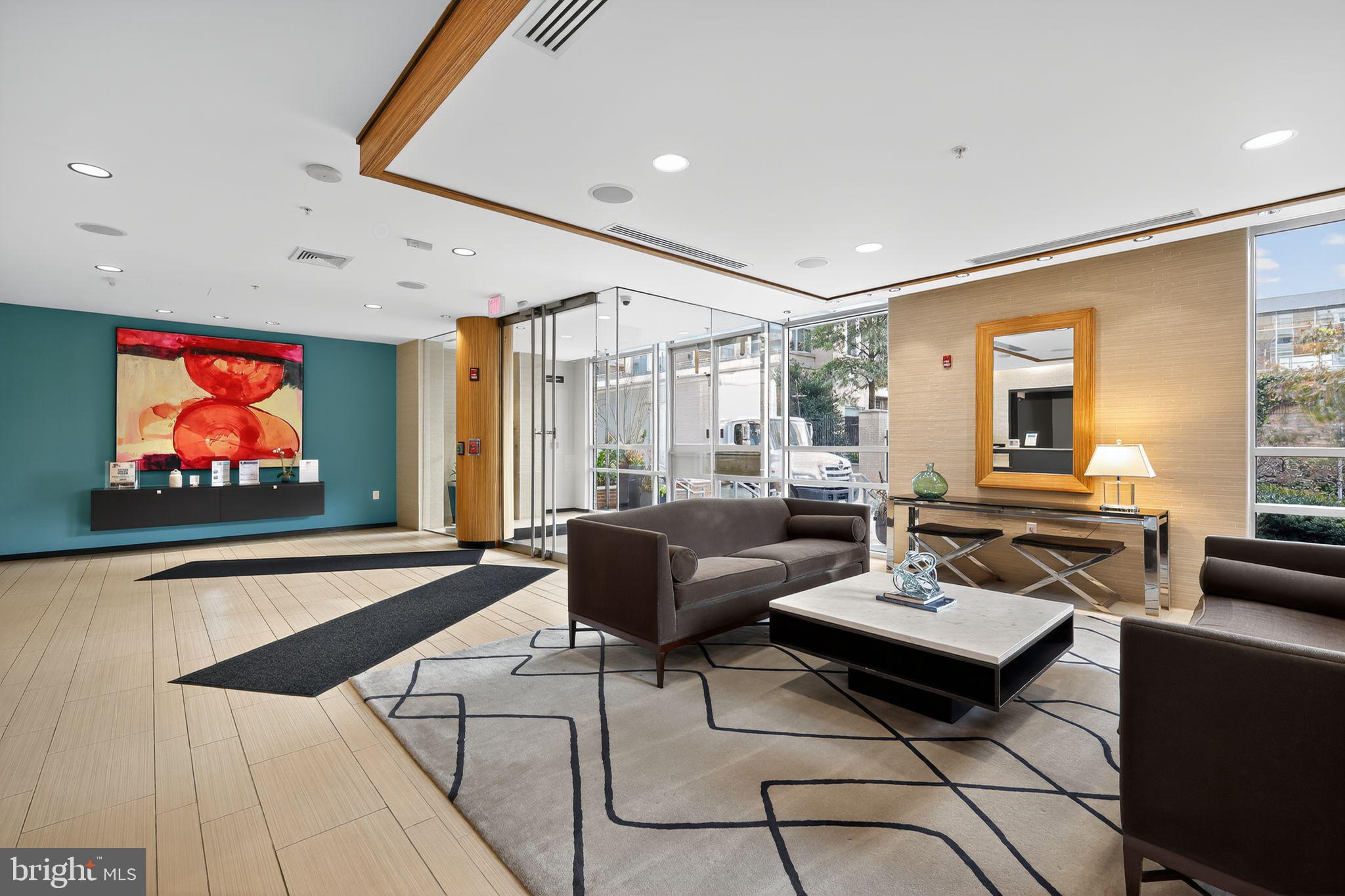 12025 New Dominion Parkway, Unit 311 Reston, VA 20190 - Photo 3 of 29 a living room with furniture and a flat screen tv