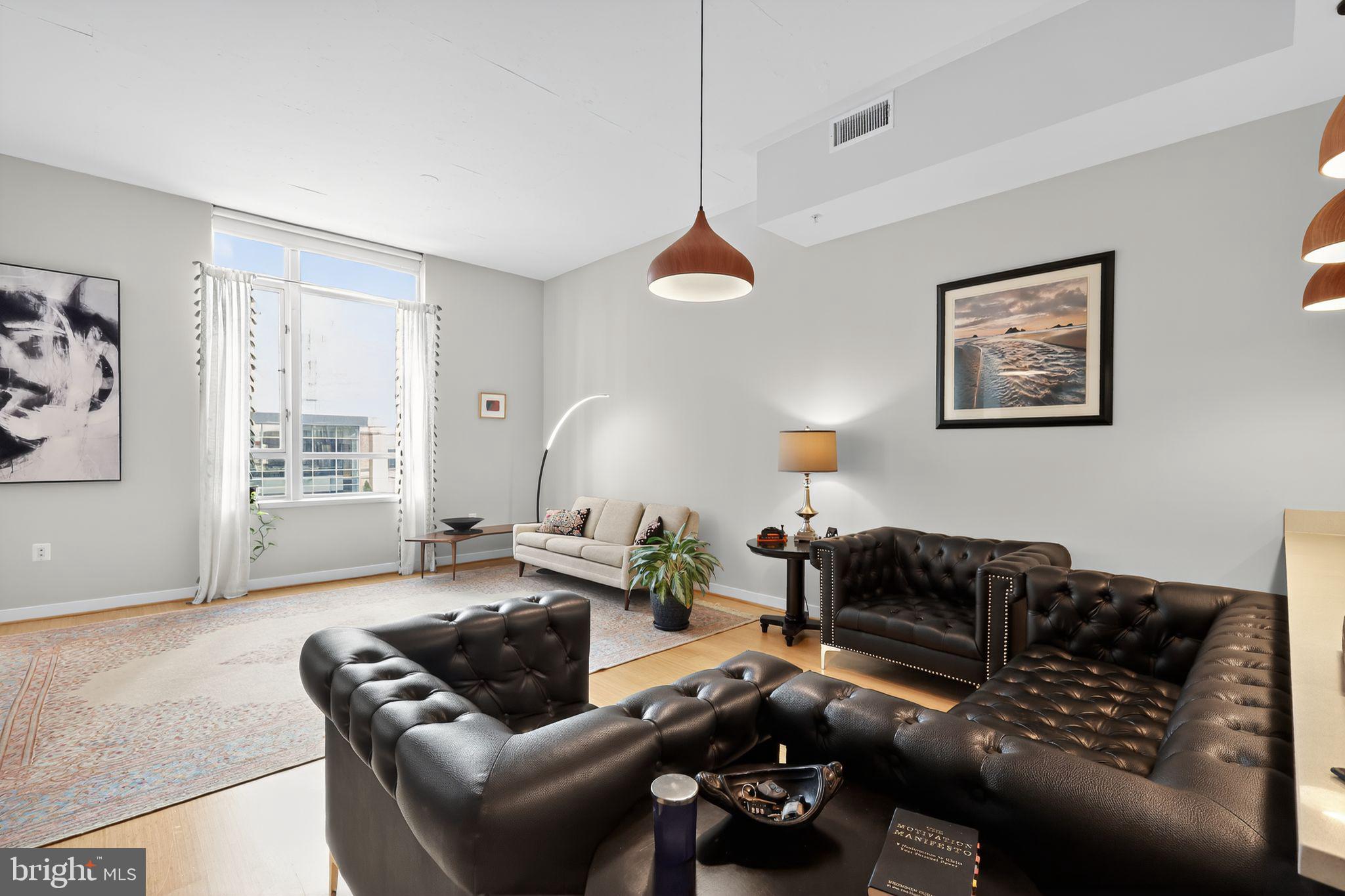 12025 New Dominion Parkway, Unit 311 Reston, VA 20190 - Photo 6 of 29 a living room with furniture a couch and a window