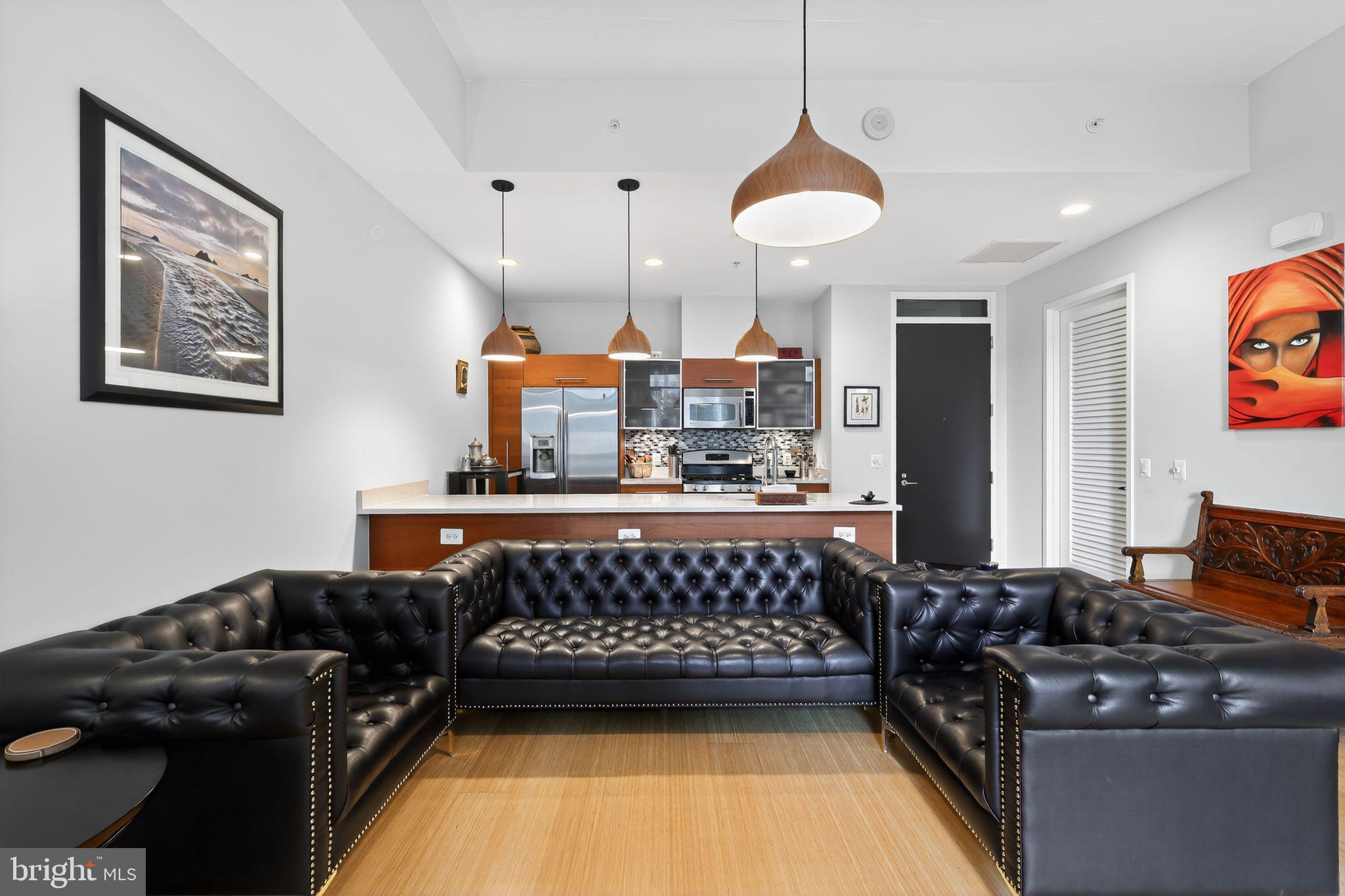12025 New Dominion Parkway, Unit 311 Reston, VA 20190 - Photo 8 of 29 a kitchen with stainless steel appliances granite countertop a stove a refrigerator a sink dishwasher and white cabinets next to a window